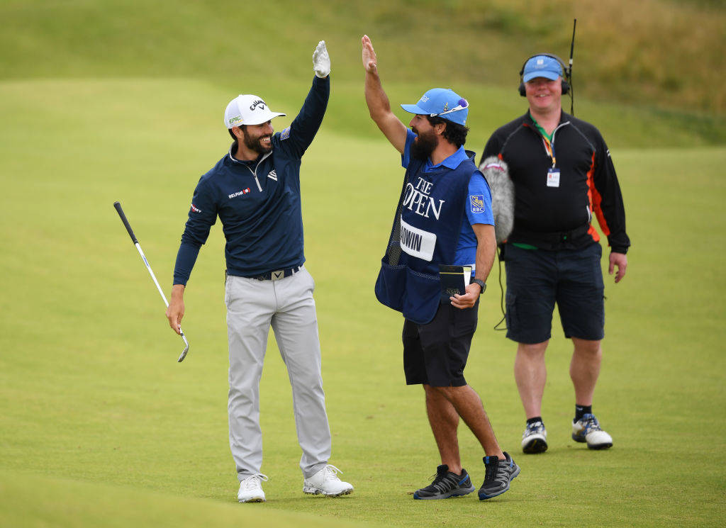 Adam Hadwin high fiving his caddie